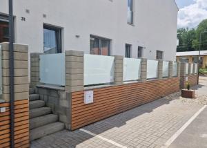 a row of mirrors on a fence in front of a building at Apartmán POD ROTUNDOU in Skalica