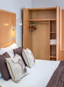 1 dormitorio con 1 cama con almohadas en High Range Lodge Hotel, en Aviemore
