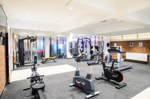a gym with treadmills and exercise bikes in a room at Tulip Inn Ludwigshafen City in Ludwigshafen am Rhein
