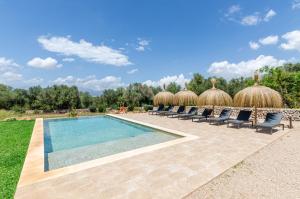 a swimming pool with chaise lounge chairs and a resort at Agroturismo Cal Tio 4, YourHouse in Costitx