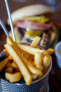 a basket of french fries and a hamburger at The White Lion Hotel in Aldeburgh