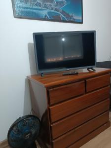 a flat screen tv sitting on top of a dresser at Flor de Canela in São Roque