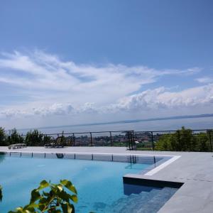 a swimming pool with a view of the ocean at My Summer Lakeside Villa with Pool and Hot Tub in Bardolino