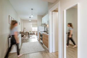 two women walking through a kitchen in a house at Lilium Luxury Apartment in Igoumenitsa