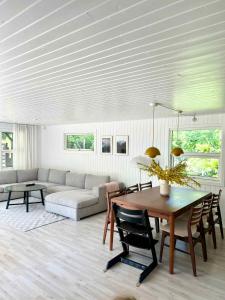 a living room with a table and a couch at Charming Summer House On A Secluded Plot in Glesborg