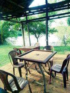 un tavolo in legno e sedie sotto un gazebo di Sigiri Wild Lake Dambulla a Dambulla