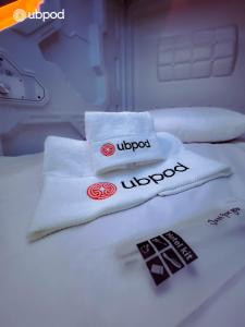 two towels sitting on top of a bed at UBPOD- The First Capsule Hotel in Mongolia in Ulaanbaatar