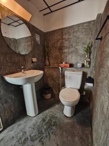a bathroom with a toilet and a sink at Palmyrah Residencies in Colombo