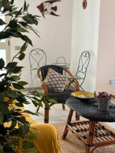 a room with chairs and a table with a bowl on it at Casa Violetta in Lotzorai