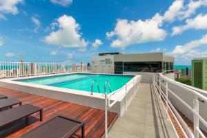 a balcony with a swimming pool on top of a building at Studio Encantador - Garagem - Piscina na Cobertura in João Pessoa