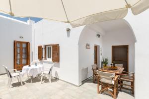 a dining room with a table and chairs at Villa Grevillea Mikri Vigla in Mikri Vigla +37 photos