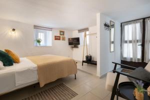 a bedroom with a bed and a television in it at Studio Amore in Dubrovnik