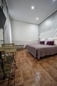 a bedroom with a bed and a table in it at Hostal Las Fuentes in Madrid