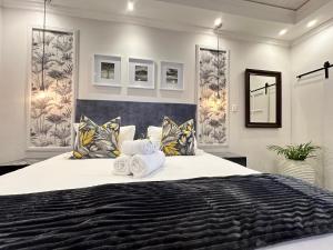 プレトリアにあるSpacube Luxury Suites and Spaのベッドルーム1室(大型ベッド1台、タオル付)