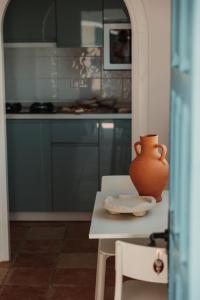 an orange vase sitting on a table in a kitchen at Bungalows El Arenal in Jávea