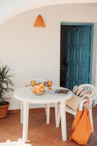 a white table with a bowl of fruit on it at Bungalows El Arenal in Jávea