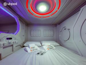 a room with a bed with a target on the ceiling at UBPOD- The First Capsule Hotel in Mongolia in Ulaanbaatar