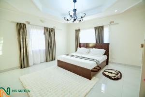a bedroom with a bed and a chandelier at The N3 Luxury Suite in Mzuzu +56 photos