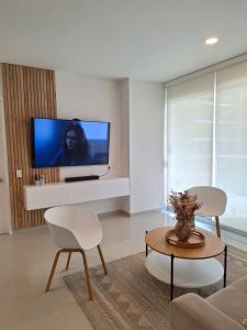 a living room with a flat screen tv on a wall at Apartamento de lujo Morros ULTRA con vista y acceso directo al mar , Cartagena de Indias in Cartagena de Indias