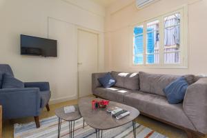 a living room with a couch and a table at Mikaella's Cozy 1-BR with 24-7 Electricity in Beirut