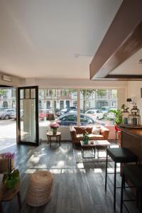 a living room with couches and tables in a building at Hotel Carlton in Ghent