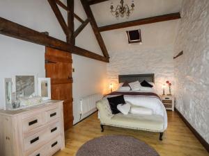 a bedroom with a bed and a vanity and a sink at Hendy Cottage in Llanbedr