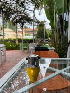 a glass table with a coffee pot on top of it at Tropical Garden Phu Quoc in Phú Quốc