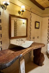 a bathroom with a sink and a mirror at La Casa De La Bodega - Wine Boutique Hotel in Cafayate
