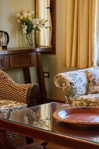 a living room with a couch and a table at La Casa De La Bodega - Wine Boutique Hotel in Cafayate