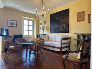 a living room with a couch and a table and chairs at Splendid Villa Sea View Alassio in Alassio