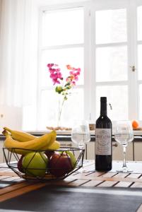 a bottle of wine and a basket of fruit on a table at Ixia Manor House in Ixia