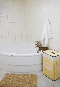 a white bathroom with a tub and a wooden box at Ixia Manor House in Ixia