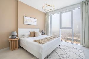 a bedroom with a large bed and a large window at GuestReady - Exuberance and refinement in Dubai