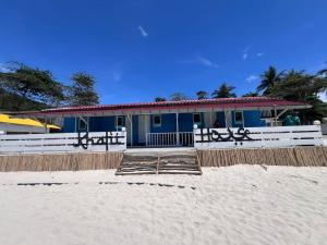 a building on the beach next to the sand at Khafii House in Kampong Pasir Panjang +11 photos