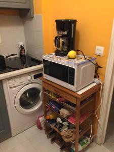 een magnetron op een tafel in een keuken bij Victoria Palace in Menton