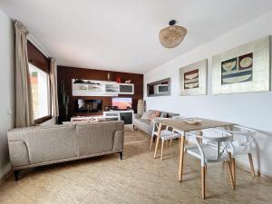 a living room with a couch and a table at LETS HOLIDAYS SEA VIEWS APARTMENT & POOL in SA GABARRA in Tossa de Mar