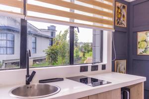 una cucina con un lavandino e una finestra di Tufaha Resort a Nanyuki