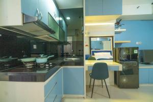 a kitchen with a counter and a chair in it at Studio at Bassura City East Jakarta Netflix in Jakarta