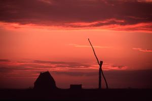 a silhouette of a wind turbine at sunset at Urbarialhof in Illmitz