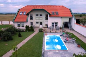 an aerial view of a house with a swimming pool at Urbarialhof in Illmitz