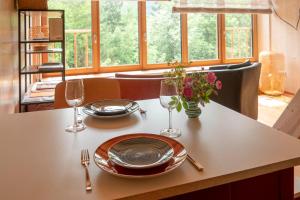 a table with plates and wine glasses on it at Servus Almtal in Scharnstein