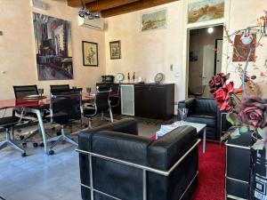 a living room with couches and tables and chairs at La Meridiana in Augusta