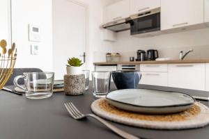 a table with a plate on top of it in a kitchen at Suite Sunset in Saint Malo +15 photos