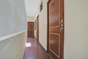 an empty hallway with a wooden door and a floor at Super OYO Flagship T.Nagar in Chennai