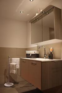 a bathroom with a sink and a mirror at Charlys Ferienwohnung in Samnaun