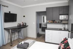 a kitchen with a counter and a table in a room at Wanderlust Private Studio Apartment in Langebaan