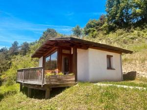 a small house on a hill with a balcony at Cabañas Agotzenea in Zubiri +12 photos