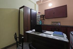 a kitchen with a desk with a laptop on it at Super OYO Flagship T.Nagar in Chennai