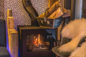 a fireplace in a living room with a fire at Stylish place-Amazing Views-3 main lifts, Apt design- vue splendide-3 Telecabines in Samoëns