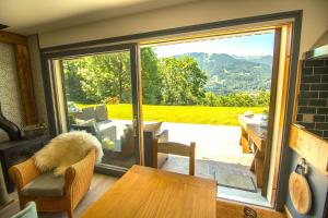 a room with a sliding glass door with a view of a patio at Stylish place-Amazing Views-3 main lifts, Apt design- vue splendide-3 Telecabines in Samoëns